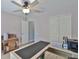 This office features a ceiling fan, L-shaped desk with a black desktop and an armoire at 7609 Clair Wood Ct, Apollo Beach, FL 33572