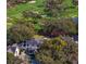 Aerial view of an estate home surrounded by mature trees and golf course at 1002 S Frankland Rd, Tampa, FL 33629