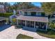 Aerial view of a home with a screened-in porch, outdoor seating, and manicured backyard at 1002 S Frankland Rd, Tampa, FL 33629