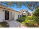Spacious backyard featuring a putting green, brick wall, and a charming white home at 1002 S Frankland Rd, Tampa, FL 33629
