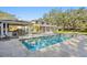 Wonderful backyard features a pool, hot tub, manicured lawn, outdoor kitchen, and outdoor space at 1002 S Frankland Rd, Tampa, FL 33629