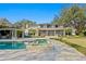 Wonderful backyard features a pool, hot tub, manicured lawn, screened porch, and outdoor space at 1002 S Frankland Rd, Tampa, FL 33629