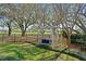 Picturesque backyard featuring lush green grass, mature trees, a swing, and manicured landscaping at 1002 S Frankland Rd, Tampa, FL 33629