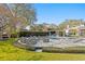 Beautiful backyard featuring an outdoor kitchen, pool, hot tub, manicured lawn and fire pit area at 1002 S Frankland Rd, Tampa, FL 33629