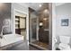 Bathroom with walk-in shower, white vanity and fixtures at 1002 S Frankland Rd, Tampa, FL 33629