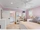 Cozy bedroom with lilac walls, plush carpet, and white furniture at 1002 S Frankland Rd, Tampa, FL 33629