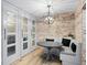 Charming breakfast nook featuring exposed brick wall and built-in seating with table at 1002 S Frankland Rd, Tampa, FL 33629