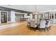 Spacious dining room with an elegant chandelier, hardwood floors, and an open layout to the kitchen area at 1002 S Frankland Rd, Tampa, FL 33629