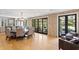 Bright dining area with hardwood floors, exposed brick walls, and large doors to an outdoor space at 1002 S Frankland Rd, Tampa, FL 33629