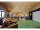 Spacious entertainment room with leather seating, bar area, and golf simulator at 1002 S Frankland Rd, Tampa, FL 33629