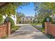 A long brick driveway leads up to this two-story home with a porte cochere at 1002 S Frankland Rd, Tampa, FL 33629