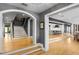 Open foyer with hardwood floors, staircase, and views into the kitchen and dining areas at 1002 S Frankland Rd, Tampa, FL 33629