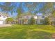 Elegant home boasting a well-kept lawn, a circular veranda, and a paved driveway at 1002 S Frankland Rd, Tampa, FL 33629