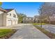Beautiful home with a long drive, well-manicured lawn, and mature trees at 1002 S Frankland Rd, Tampa, FL 33629