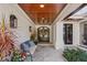 Charming covered front porch with seating, planters, and elegant double doors at 1002 S Frankland Rd, Tampa, FL 33629