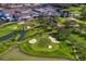 An aerial view of a golf course with water features and clubhouse at 1002 S Frankland Rd, Tampa, FL 33629