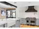 Bright kitchen featuring stainless steel appliances, an island sink, and a range hood at 1002 S Frankland Rd, Tampa, FL 33629