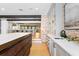 Bright kitchen featuring a large island, modern countertops, and brick accent wall at 1002 S Frankland Rd, Tampa, FL 33629