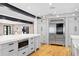 Bright kitchen with island seating, a stainless steel refrigerator, and hardwood floors at 1002 S Frankland Rd, Tampa, FL 33629