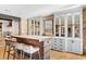 Expansive kitchen island with seating, brick accent wall, and mirrored-door cabinets at 1002 S Frankland Rd, Tampa, FL 33629