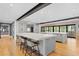 Open kitchen with a spacious island, stainless steel refrigerator, and hardwood floors at 1002 S Frankland Rd, Tampa, FL 33629