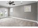 Spacious living room with windows, ceiling fan and hardwood floors at 1002 S Frankland Rd, Tampa, FL 33629