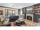 Cozy living room featuring a fireplace, plush seating, and natural light from the bay window at 1002 S Frankland Rd, Tampa, FL 33629