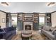 Living room features a fireplace, built-in shelving, neutral paint, hardwood floors, and matching sofas at 1002 S Frankland Rd, Tampa, FL 33629