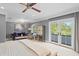 Airy main bedroom featuring a ceiling fan, sitting area, and doors to a private balcony at 1002 S Frankland Rd, Tampa, FL 33629