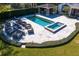 Aerial shot of a stunning outdoor area, including a pool, spa, fire pit, and covered bar area at 1002 S Frankland Rd, Tampa, FL 33629