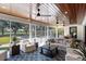 Cozy sunroom featuring outdoor views, wood ceilings, ceiling fans, and comfortable seating area at 1002 S Frankland Rd, Tampa, FL 33629