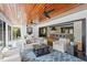 Inviting sunroom with wood ceilings, ceiling fans, and seamless connection to the kitchen at 1002 S Frankland Rd, Tampa, FL 33629