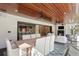 Open-concept sunroom with wood ceilings, ceiling fans, connects to breakfast nook and kitchen at 1002 S Frankland Rd, Tampa, FL 33629