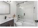 Updated bathroom featuring a sleek vanity, modern fixtures, and a glass-enclosed shower over the tub at 1012 W Berry Ave, Tampa, FL 33603