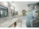 Modern bathroom featuring a double vanity, walk-in shower, and stylish gray tiling for a luxurious feel at 105 Country Villas Dr, Safety Harbor, FL 34695