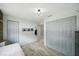 Bright bedroom featuring wood-look floors, large closets, and a neutral color palette at 105 Country Villas Dr, Safety Harbor, FL 34695