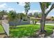 Charming home with a well-manicured lawn, mature palm trees, and a partial white picket fence adding to its curb appeal at 105 Country Villas Dr, Safety Harbor, FL 34695