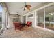 Relax on this covered patio with beautiful brick flooring and stylish red furniture at 11505 Heron Hills Ln, Riverview, FL 33569