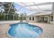 Inviting screened-in pool area with pavers and ample seating space for relaxing and entertaining at 11505 Heron Hills Ln, Riverview, FL 33569