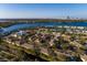 Stunning aerial view of the community with water views and Tampa skyline in the background at 122 Coquina Bay Dr, St Petersburg, FL 33705