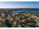 Aerial view of entire neighborhood with water, boat docks, and Tampa Bay in background at 122 Coquina Bay Dr, St Petersburg, FL 33705