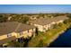 Aerial view of townhomes that are built alongside a creek, showing neighborhood at 122 Coquina Bay Dr, St Petersburg, FL 33705