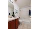 Bright bathroom with cherry vanity, a bathtub, and a shower combo at 122 Coquina Bay Dr, St Petersburg, FL 33705