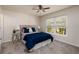 Cozy bedroom with carpet, a ceiling fan, a large window, and tasteful decor at 122 Coquina Bay Dr, St Petersburg, FL 33705