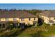 Aerial view of the back of the townhomes with green grass and exterior patios at 122 Coquina Bay Dr, St Petersburg, FL 33705
