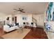 Bright living room features hardwood floors, ceiling fan, comfortable seating, and a staircase leading to the second floor at 122 Coquina Bay Dr, St Petersburg, FL 33705