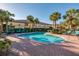 Community pool with lots of chairs and palm trees surrounding the area at 122 Coquina Bay Dr, St Petersburg, FL 33705