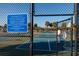 Tennis and pickleball court rules, with outdoor tennis court behind gate at 122 Coquina Bay Dr, St Petersburg, FL 33705
