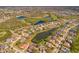 Scenic aerial view of a residential community featuring multiple ponds, a golf course and mature trees at 12933 Prestwick Dr, Riverview, FL 33579