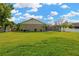 Spacious backyard featuring lush green grass, a screened-in patio, and mature landscaping at 12933 Prestwick Dr, Riverview, FL 33579